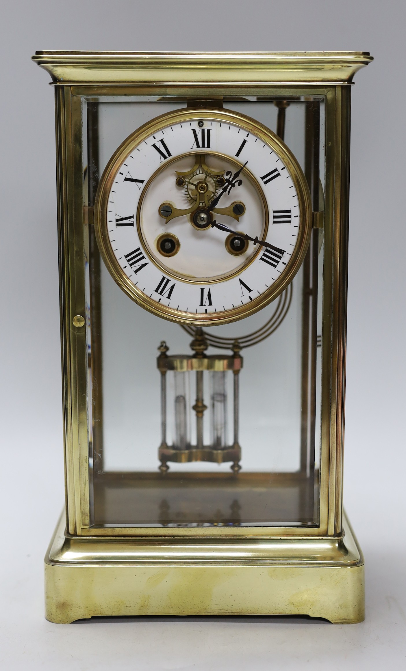 A late 19th century brass and four glass mantel clock, 30cm high
